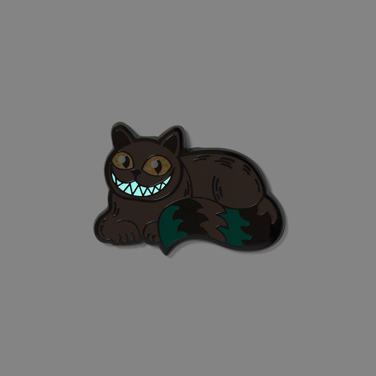 Cheshire Cat pin badge with glow-in-the-dark enamel detailing inspired by the MinaLima Classics illustrated book.