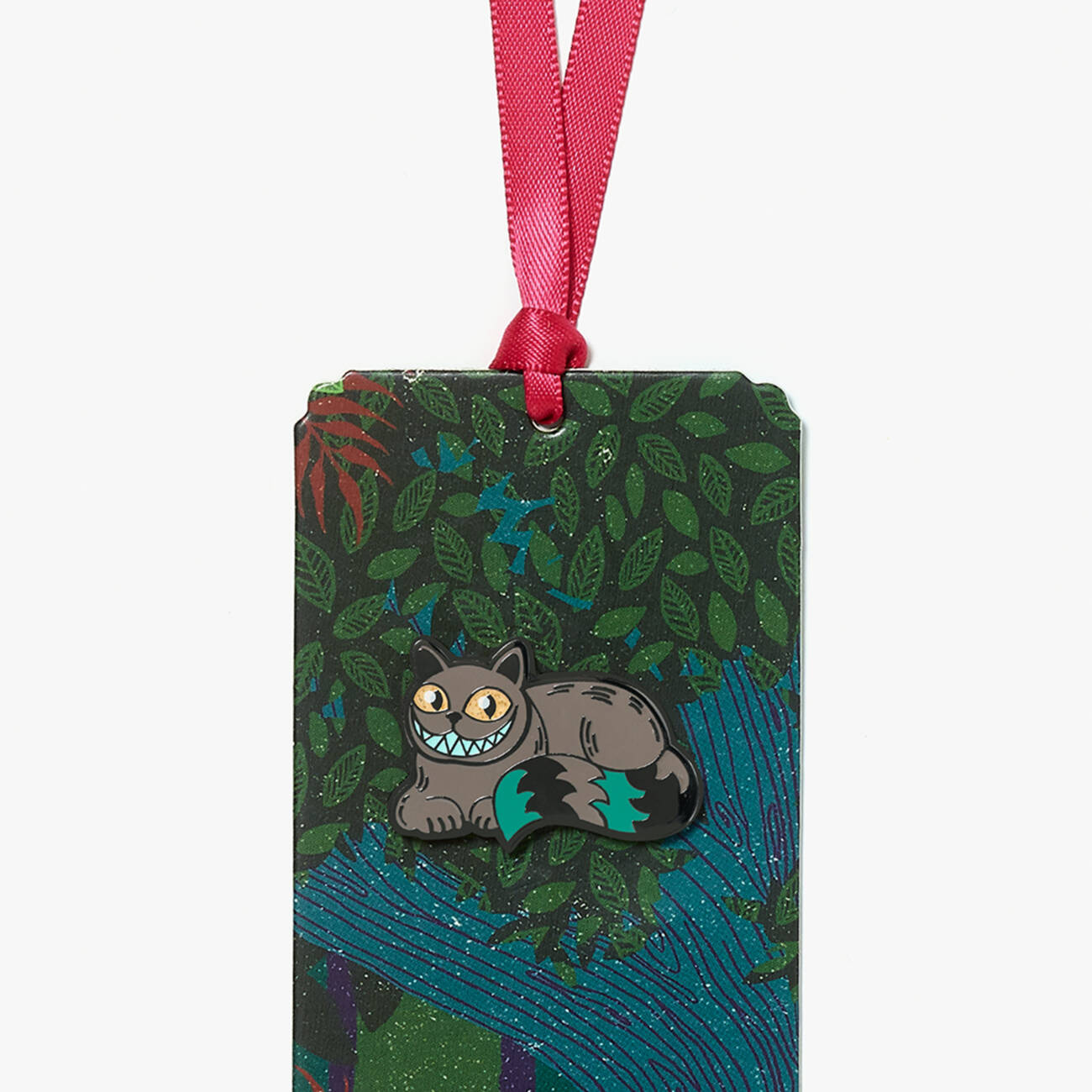 Cheshire Cat pin badge and ‘Alice’s Adventures in Wonderland & Through the Looking-Glass’ bookmark inspired by the MinaLima Classics illustrated book - zoomed in view.